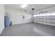Spacious garage features a gray epoxy floor and a large garage door for easy access at 10002 Brown Burrow St, Orlando, FL 32829