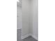 Neutral hallway showcasing gray tiled floors, a recessed ceiling light, and smooth, modern walls at 10002 Brown Burrow St, Orlando, FL 32829