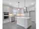 Modern kitchen with white cabinets, stainless steel appliances, subway tile backsplash, and a center island at 10002 Brown Burrow St, Orlando, FL 32829