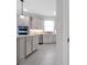 Spacious kitchen features white countertops and cabinets, stainless steel appliances, and tiled floors at 10002 Brown Burrow St, Orlando, FL 32829