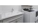 Convenient laundry room includes modern washer/dryer set and a utility sink at 10002 Brown Burrow St, Orlando, FL 32829