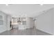 Open-concept living room connects to the kitchen, featuring tiled floors and natural light at 10002 Brown Burrow St, Orlando, FL 32829