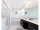 Bright, airy bathroom featuring a modern vanity, tub with marble surround, and glass enclosed shower at 1013 Leader St, Davenport, FL 33896
