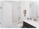 Bright bathroom featuring a shower-tub combo and a sleek vanity with modern fixtures at 1013 Leader St, Davenport, FL 33896