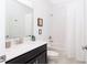 Bright bathroom featuring a shower-tub combo, framed art and a dark vanity at 1013 Leader St, Davenport, FL 33896
