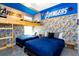 Themed bedroom with superhero wallpaper, custom bunk beds, and vibrant blue bedding and accents at 1013 Leader St, Davenport, FL 33896