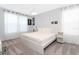 Bright modern bedroom featuring a large bed, sheer curtains and stylish wall decor at 1013 Leader St, Davenport, FL 33896