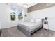 Comfortable bedroom with a gray bed frame, large windows, soft carpeting, and neutral wall color at 1013 Leader St, Davenport, FL 33896