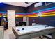 Fun game room with arcade games, air hockey, and vibrant neon decorations at 1013 Leader St, Davenport, FL 33896