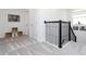 Hallway featuring carpeted floors and a railing with black wrought iron spindles at 1013 Leader St, Davenport, FL 33896