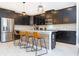 Contemporary kitchen with black cabinetry, stainless steel appliances, a center island, and modern pendant lighting at 1013 Leader St, Davenport, FL 33896
