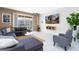 Modern living room with a gray sectional sofa, glass coffee table, large TV, and sliding glass doors at 1013 Leader St, Davenport, FL 33896