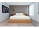 Serene main bedroom with a light wood platform bed, neutral decor, and soft carpeting at 1013 Leader St, Davenport, FL 33896