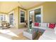 Covered outdoor patio featuring an outdoor couch, table, and barbecue with a pool view at 1013 Leader St, Davenport, FL 33896