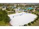 Aerial view of a sand volleyball court with community pool and clubhouse in background at 1013 Leader St, Davenport, FL 33896