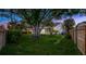 Large backyard featuring lush grass, mature trees, partial pool view, and fenced perimeter, perfect for privacy at 1027 Dees Dr, Oviedo, FL 32765