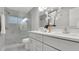 Elegant bathroom with a double vanity, glass-enclosed shower, and contemporary fixtures at 1027 Dees Dr, Oviedo, FL 32765
