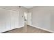 Empty bedroom shows hardwood floors, neutral colored walls, white trim and closet at 1027 Dees Dr, Oviedo, FL 32765