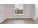Empty bedroom shows hardwood floors, neutral colored walls and white trim throughout the room at 1027 Dees Dr, Oviedo, FL 32765