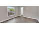 Empty bedroom shows hardwood floors, neutral colored walls, white trim and access to a closet at 1027 Dees Dr, Oviedo, FL 32765