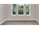 This bedroom has hardwood floors and a trio of windows overlooking a wooded area at 1027 Dees Dr, Oviedo, FL 32765