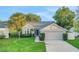 Charming single-Gathering home with well-manicured lawn, mature trees, and a two-car garage at 1027 Dees Dr, Oviedo, FL 32765