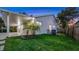 Exterior backyard view of the home with covered patio and grassy yard, including sunset at 1027 Dees Dr, Oviedo, FL 32765