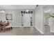 Bright, open foyer with a view of the dining area, featuring stylish flooring and a decorative front door at 1027 Dees Dr, Oviedo, FL 32765