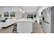 Open-concept kitchen boasts a large island with a sink and barstool seating and stainless steel appliances at 1027 Dees Dr, Oviedo, FL 32765