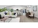 Open concept living space with modern decor, stainless steel appliances, hardwood floors and lots of natural light at 1027 Dees Dr, Oviedo, FL 32765