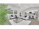 Expansive living room with a modern, open design, seamlessly connecting to a bright, spacious kitchen at 1027 Dees Dr, Oviedo, FL 32765