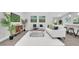 Bright, airy living room featuring modern decor, white furniture, and stylish flooring throughout at 1027 Dees Dr, Oviedo, FL 32765