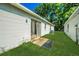 Exterior backyard featuring a sliding glass door and green grass at 1073 Hamlet Dr, Maitland, FL 32751