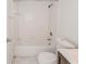 Bathroom features tiled shower-tub combo, white tile surround and updated toilet at 1073 Hamlet Dr, Maitland, FL 32751