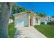 Charming single-story home featuring a well-manicured lawn, attached garage, and mature trees at 1073 Hamlet Dr, Maitland, FL 32751