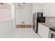 Kitchen area showcasing stainless steel refrigerator, white cabinets, and granite countertops at 1073 Hamlet Dr, Maitland, FL 32751