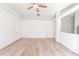 Expansive living room with wood-look floors and multiple doorways, offering versatile layout options at 1073 Hamlet Dr, Maitland, FL 32751