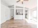 Open-concept living area with wood floors, ceiling fan, and seamless flow into the kitchen at 1073 Hamlet Dr, Maitland, FL 32751