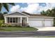 Beautiful single-Gathering home with a three-car garage, landscaped yard and classic architectural details at 12989 Trovita Dr, Grand Island, FL 32735