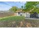 Large backyard with a wood fence, a patio, green grass, and mature trees at 1397 Candlewyck Dr, Orlando, FL 32807