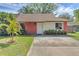Charming single-story home with a well-manicured lawn and brick accents on the facade at 1397 Candlewyck Dr, Orlando, FL 32807
