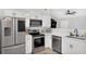 Modern kitchen featuring stainless steel appliances, white cabinets, and a neutral color scheme at 1397 Candlewyck Dr, Orlando, FL 32807