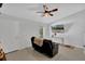Well-lit living area with tile flooring, fan, and a view to the outdoors through a window at 1397 Candlewyck Dr, Orlando, FL 32807