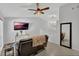 Modern living room featuring tile floors, neutral walls, and a large wall-mounted TV at 1397 Candlewyck Dr, Orlando, FL 32807