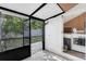 Enclosed patio featuring tile floors, storage closet with washer and dryer, and views of the backyard at 1397 Candlewyck Dr, Orlando, FL 32807