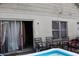 Backyard of home with chairs, windows, and sliding glass door, featuring an above ground pool at 14057 Ithaca Way, Orlando, FL 32826