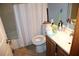 Compact bathroom features neutral fixtures and tiling ready for upgrades and personalization at 14057 Ithaca Way, Orlando, FL 32826