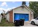 Exterior view of a cozy one-story home, complemented by brick details and a well-maintained lawn at 14057 Ithaca Way, Orlando, FL 32826