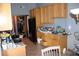 Kitchen with wooden cabinetry, tile flooring, and appliances at 14057 Ithaca Way, Orlando, FL 32826