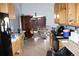 Kitchen with wooden cabinets, appliances, and dining area at 14057 Ithaca Way, Orlando, FL 32826
